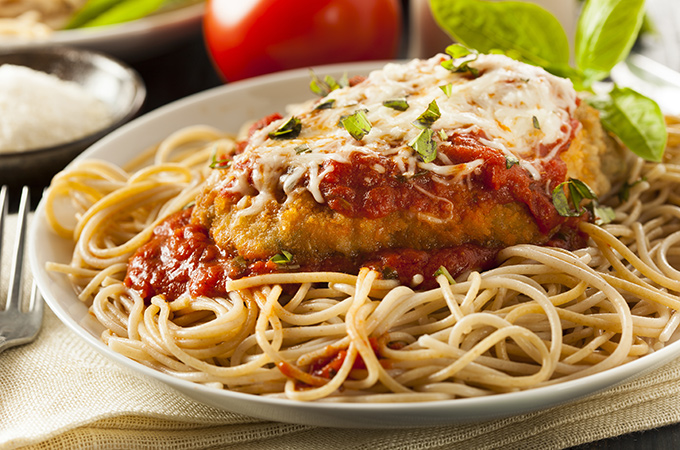  Chicken Parmigiana over a bed of spaghetti. 