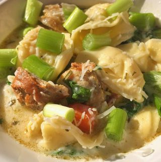 White creamy tortellini soup with sausage.