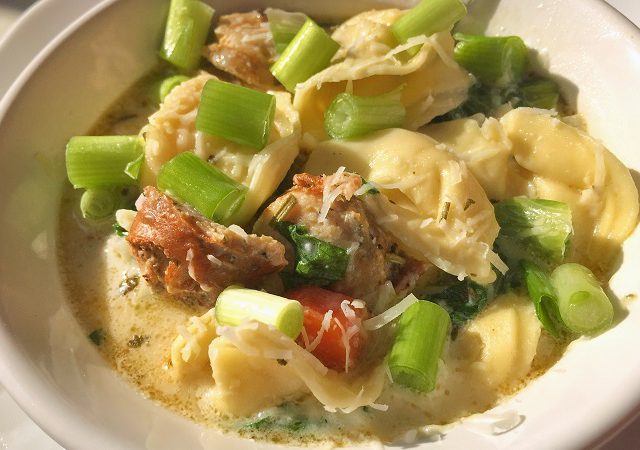 White creamy tortellini soup with sausage.