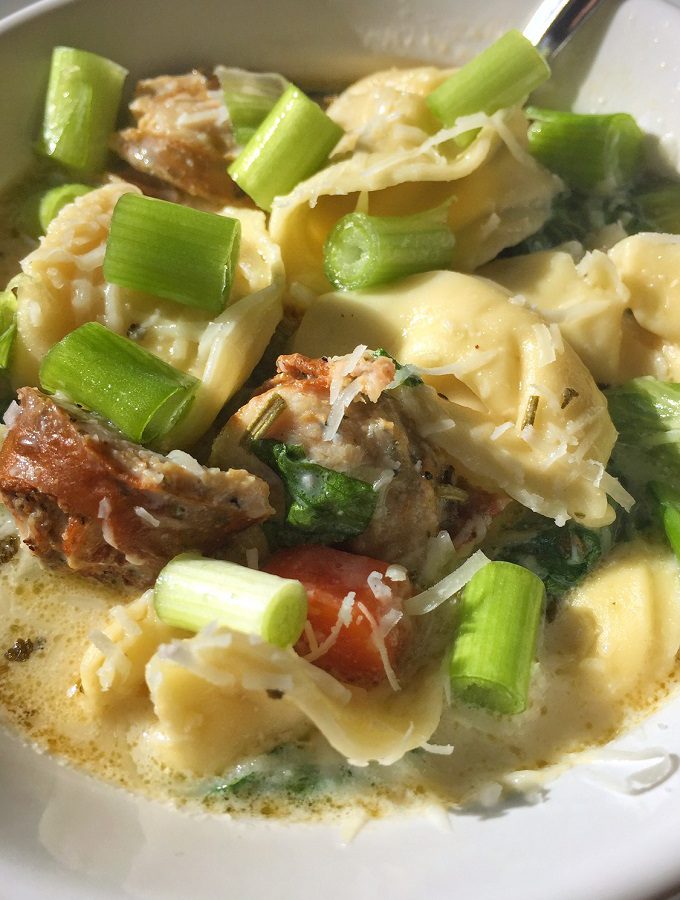 White creamy tortellini soup with sausage.