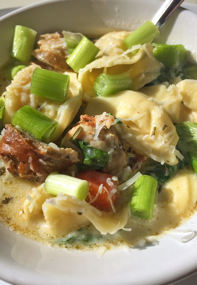 White creamy tortellini soup with sausage.