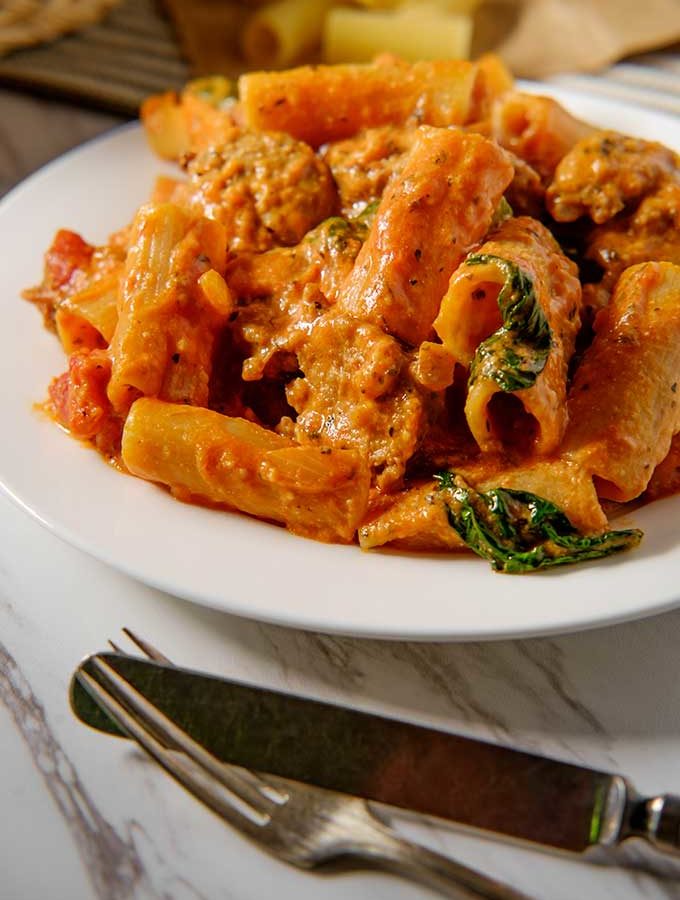 Rigatoni with a creamy vodka sauce with sausage and spinach.